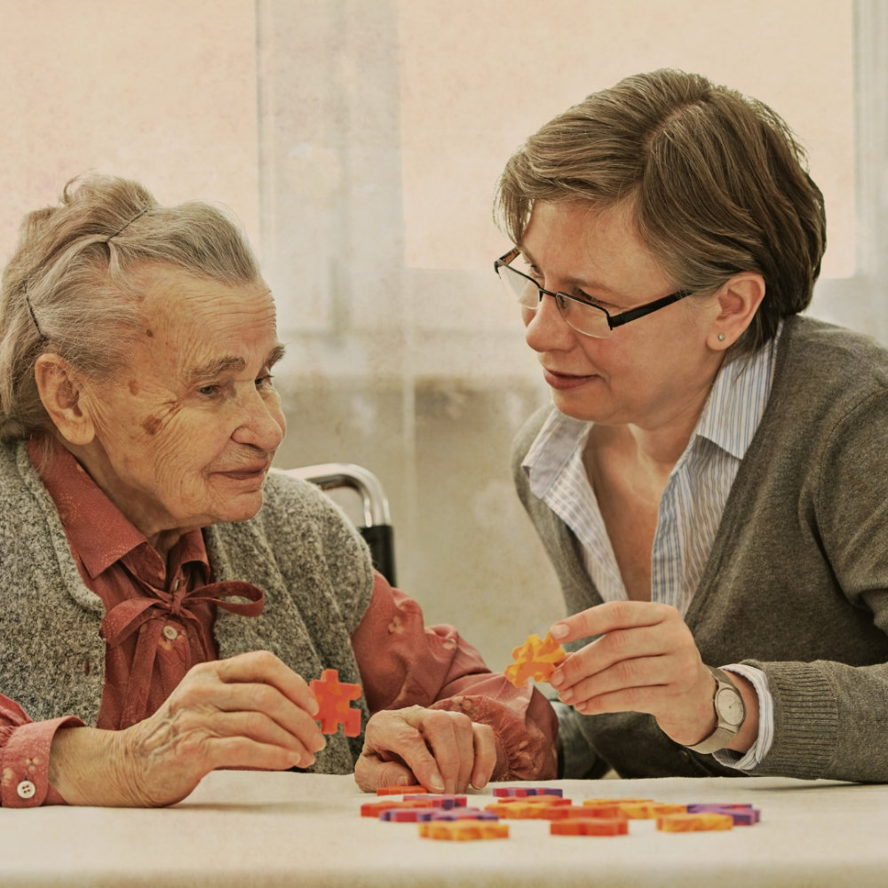 caregiver helping client with a puzzle